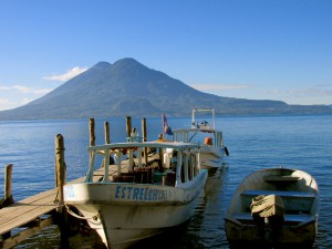 The sturdy craft that transported us across the lake to San Pedro rests against the dock, closest to the volcano.