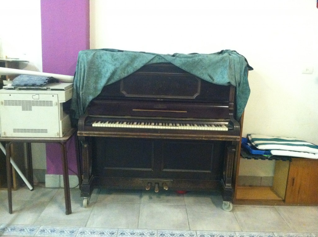 This is the old piano that was donated to Fundmind years ago.  Today, the director told me it dates back to just after WWII, and it's from a German brand.  They all ask me if it sounds okay, and apologize for it's age.  It's really a great piano though, and quite in tune (all things considered).