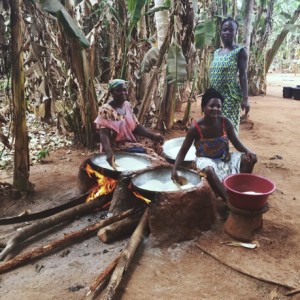Women drying sieved Cassava dough to make Gari