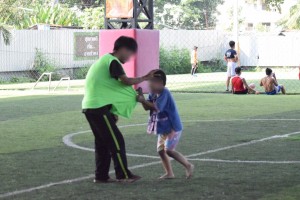 Andy playing with one of the younger boys on the soccer field.