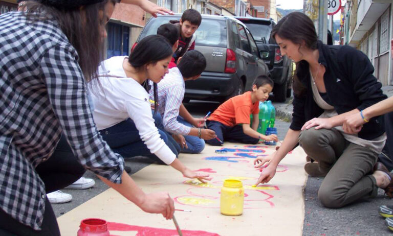 People gather together to paint a banner